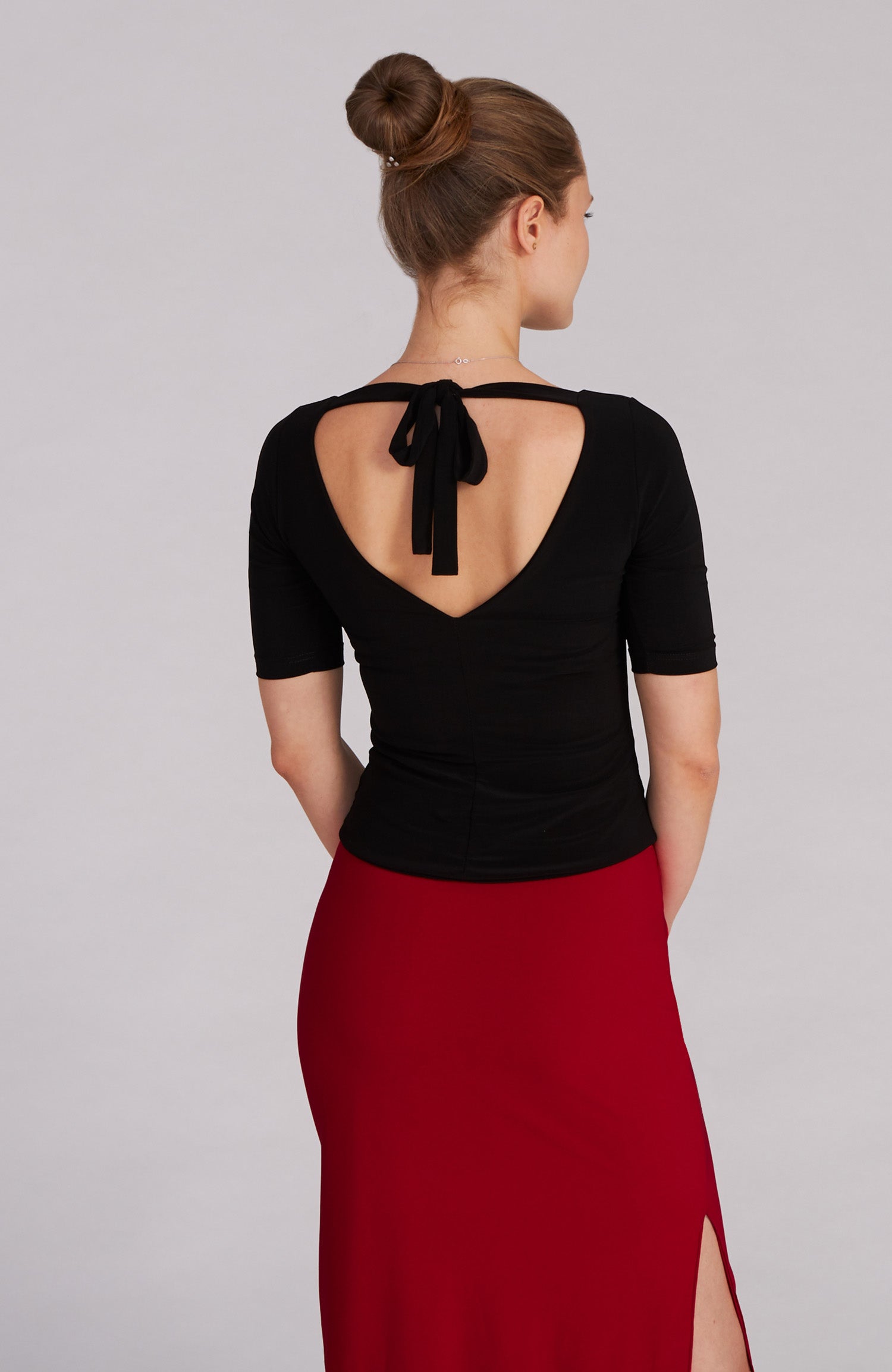 Black fitted tango top ANGEL with elbow-length sleeves; an elegant dance top featuring a bateau neckline and back bow.