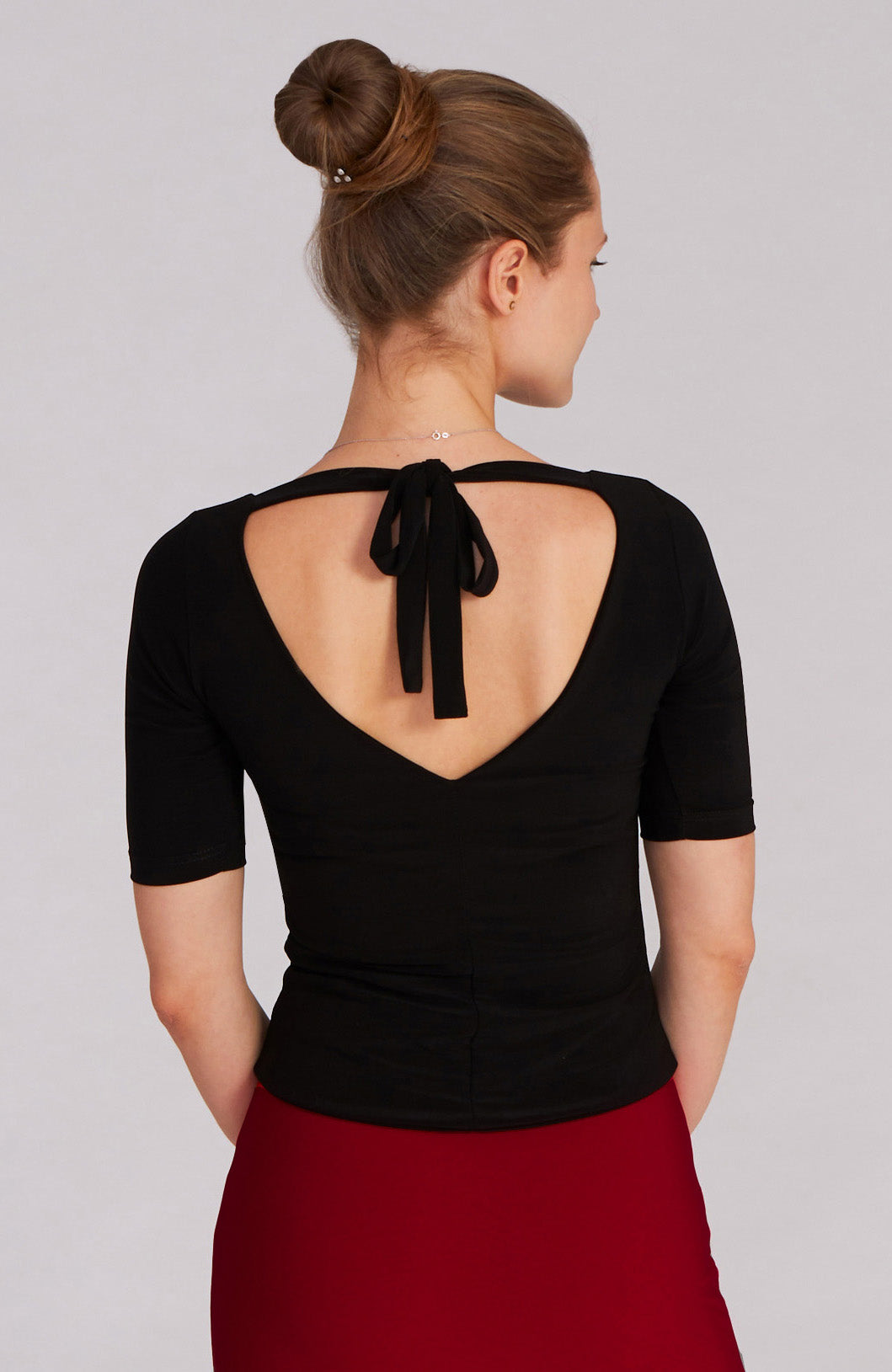 Black fitted tango top ANGEL with elbow-length sleeves; an elegant dance top featuring a bateau neckline and back bow.