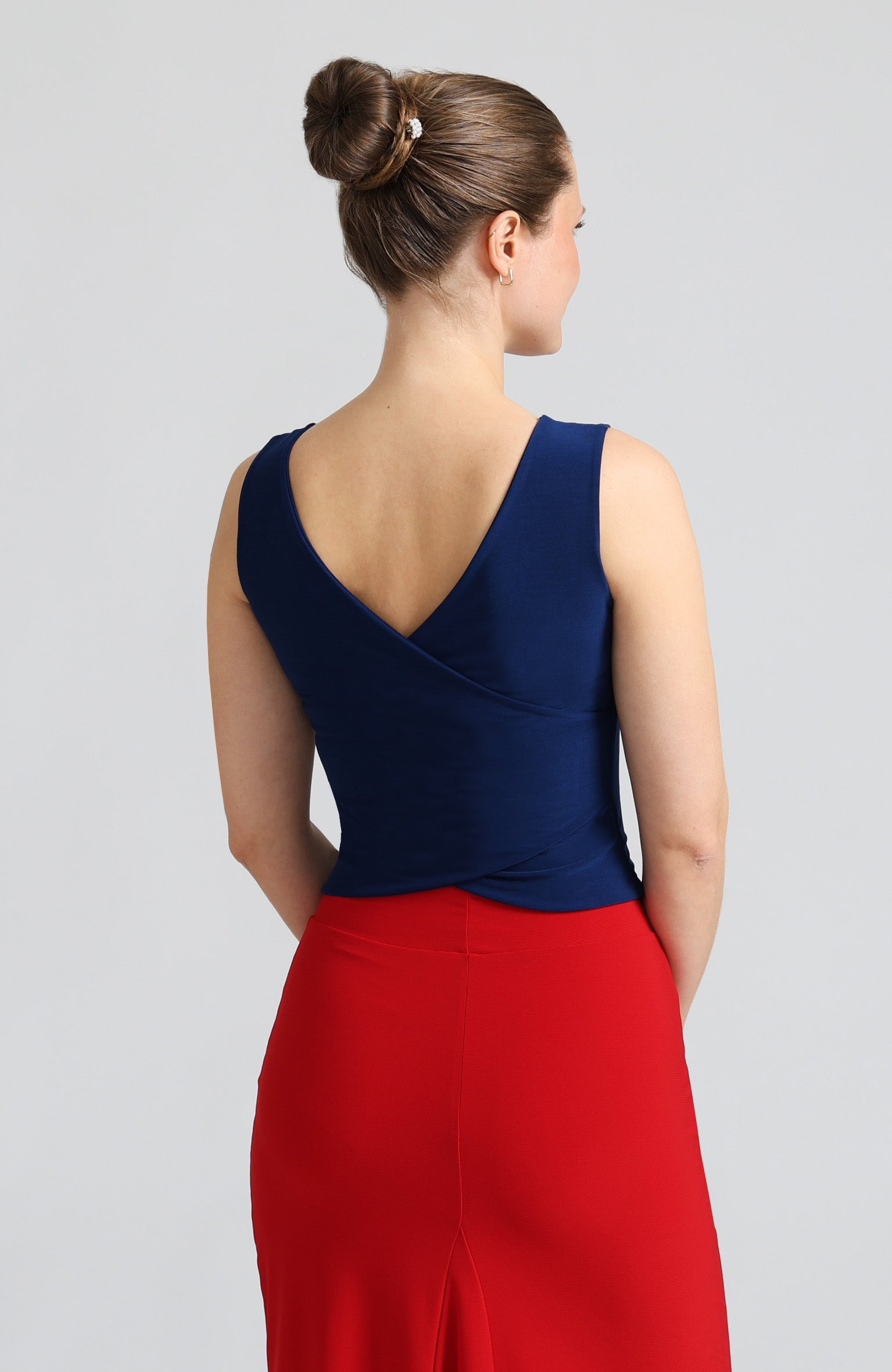 Blue cross back top DANIELA with a bateau neckline and open V-back; a double-layered stretch crop top for dance and evening wear.