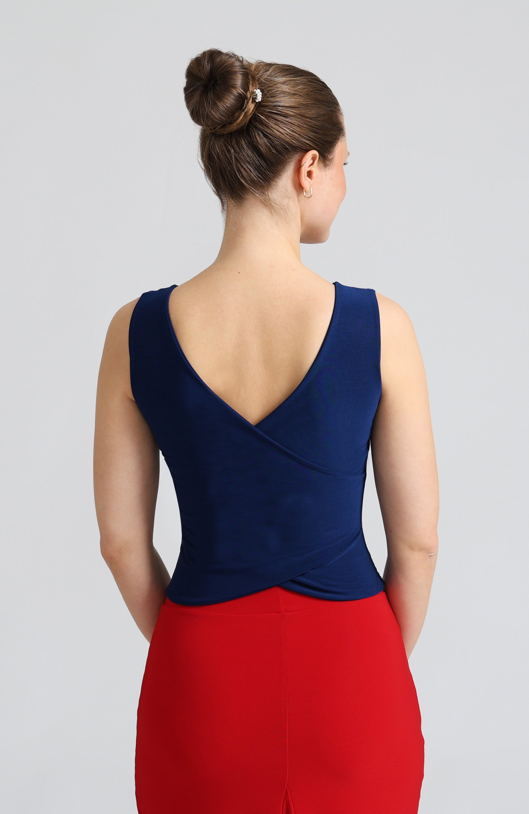 Blue cross back top DANIELA with a bateau neckline and open V-back; a double-layered stretch crop top for dance and evening wear.