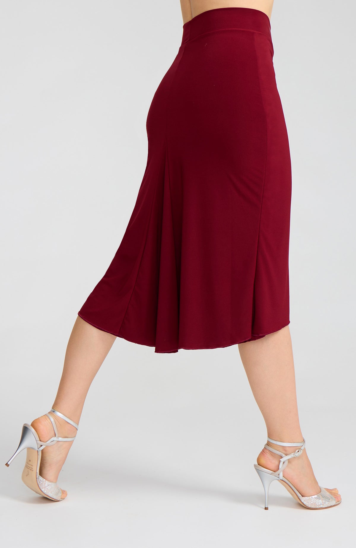 Model wearing the JAZMIN bordeaux red godet tango skirt on the dance floor.