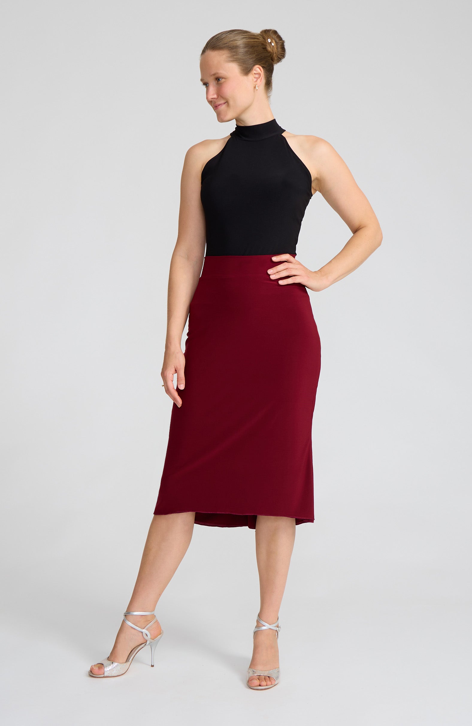 Model wearing the JAZMIN bordeaux red godet tango skirt on the dance floor.