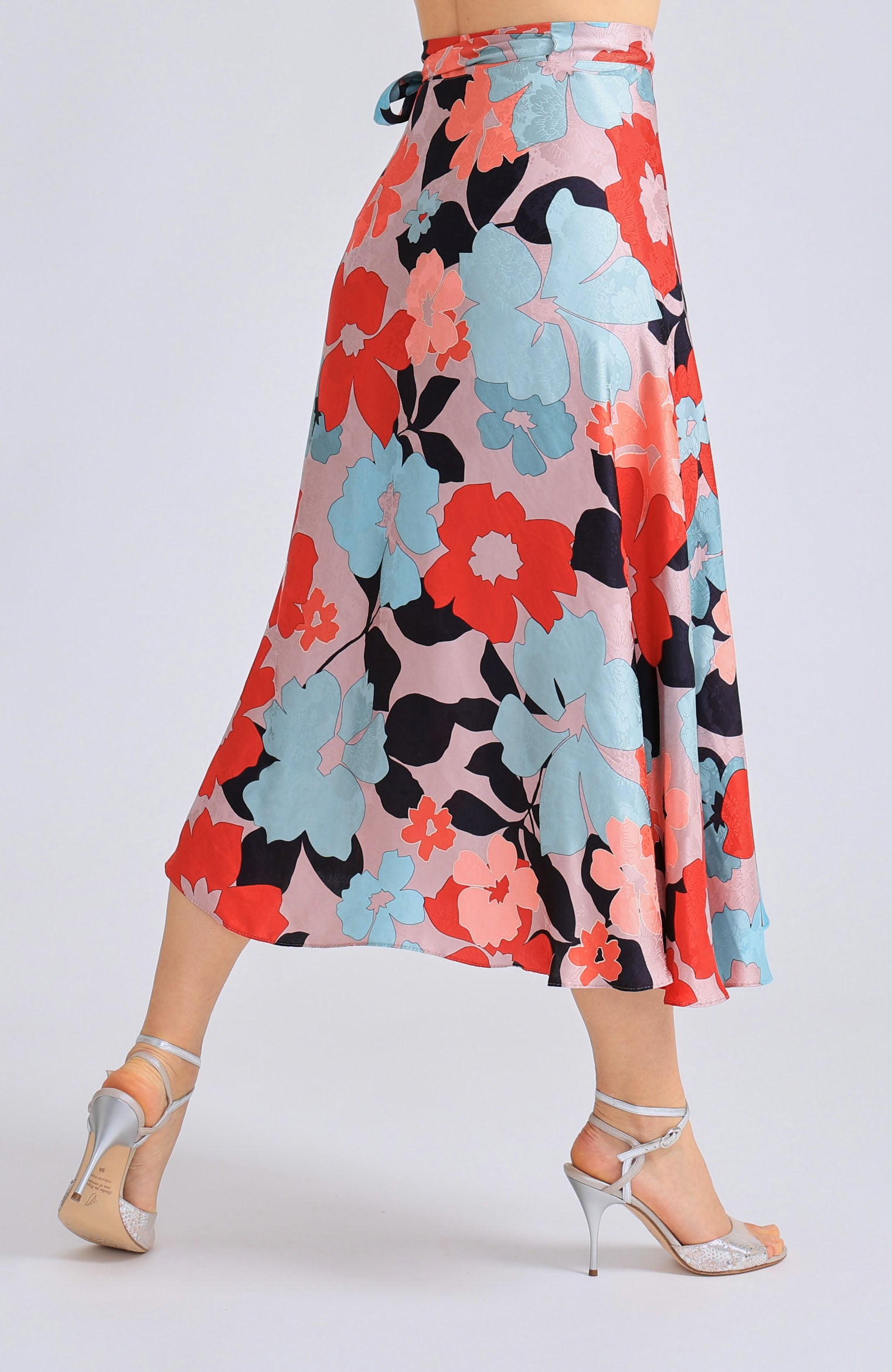 Long wrap tango skirt GINA featuring a vibrant red blossom print and a flowing silhouette that opens elegantly in motion.