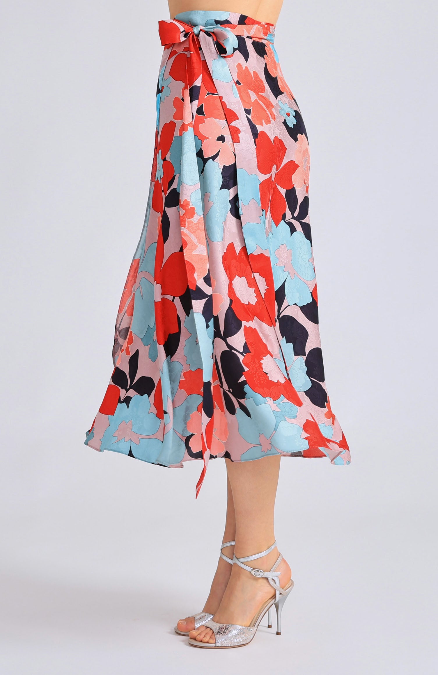 Long wrap tango skirt GINA featuring a vibrant red blossom print and a flowing silhouette that opens elegantly in motion.
