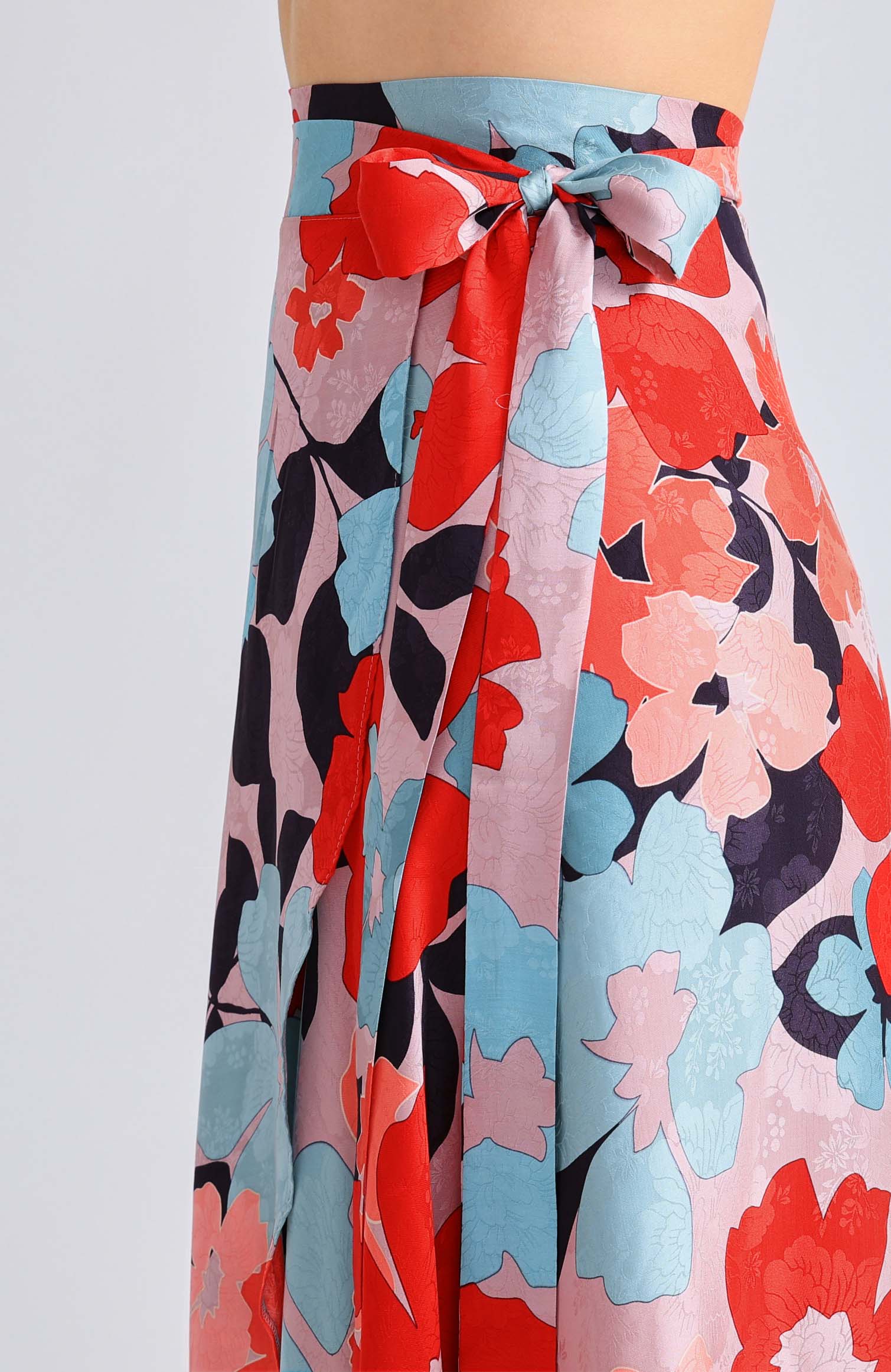 Close-up of the adjustable waist tie on the GINA long wrap tango skirt in red blossom print.