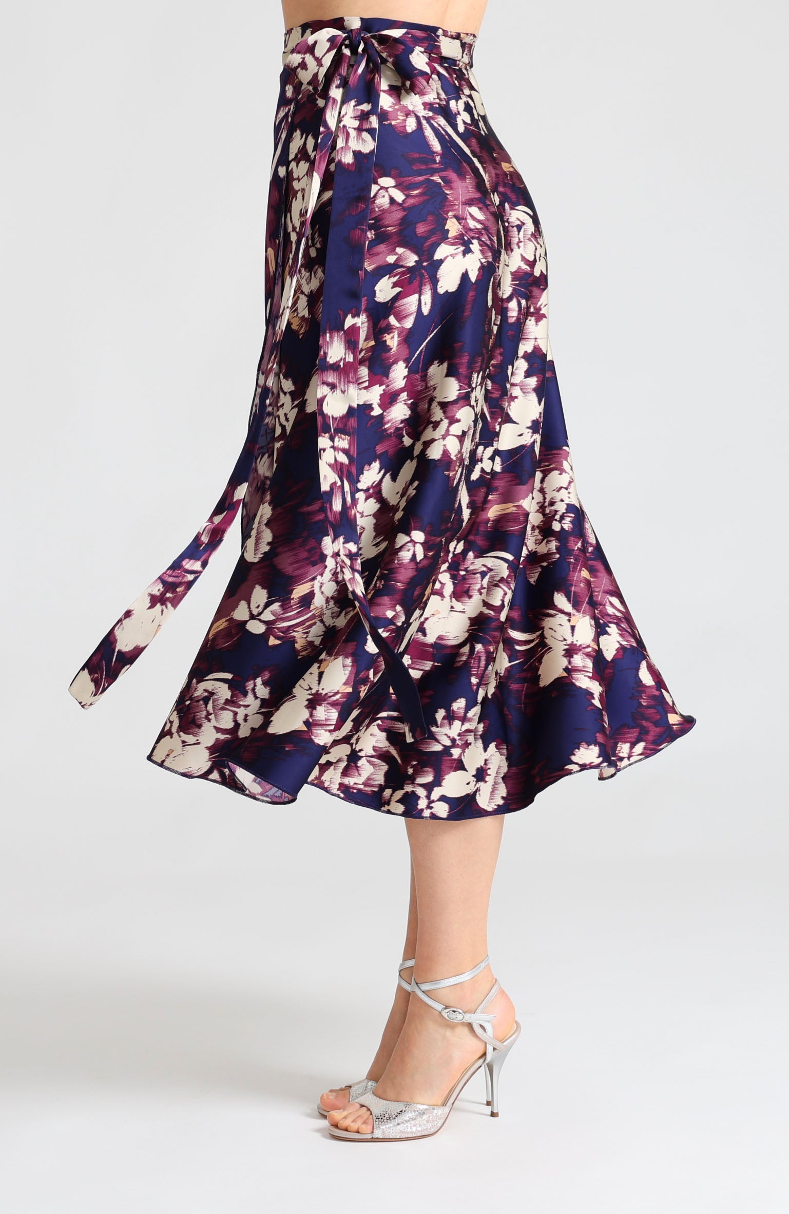 Long wrap tango skirt in blue abstract print – vibrant artistic design highlighting leg movement.