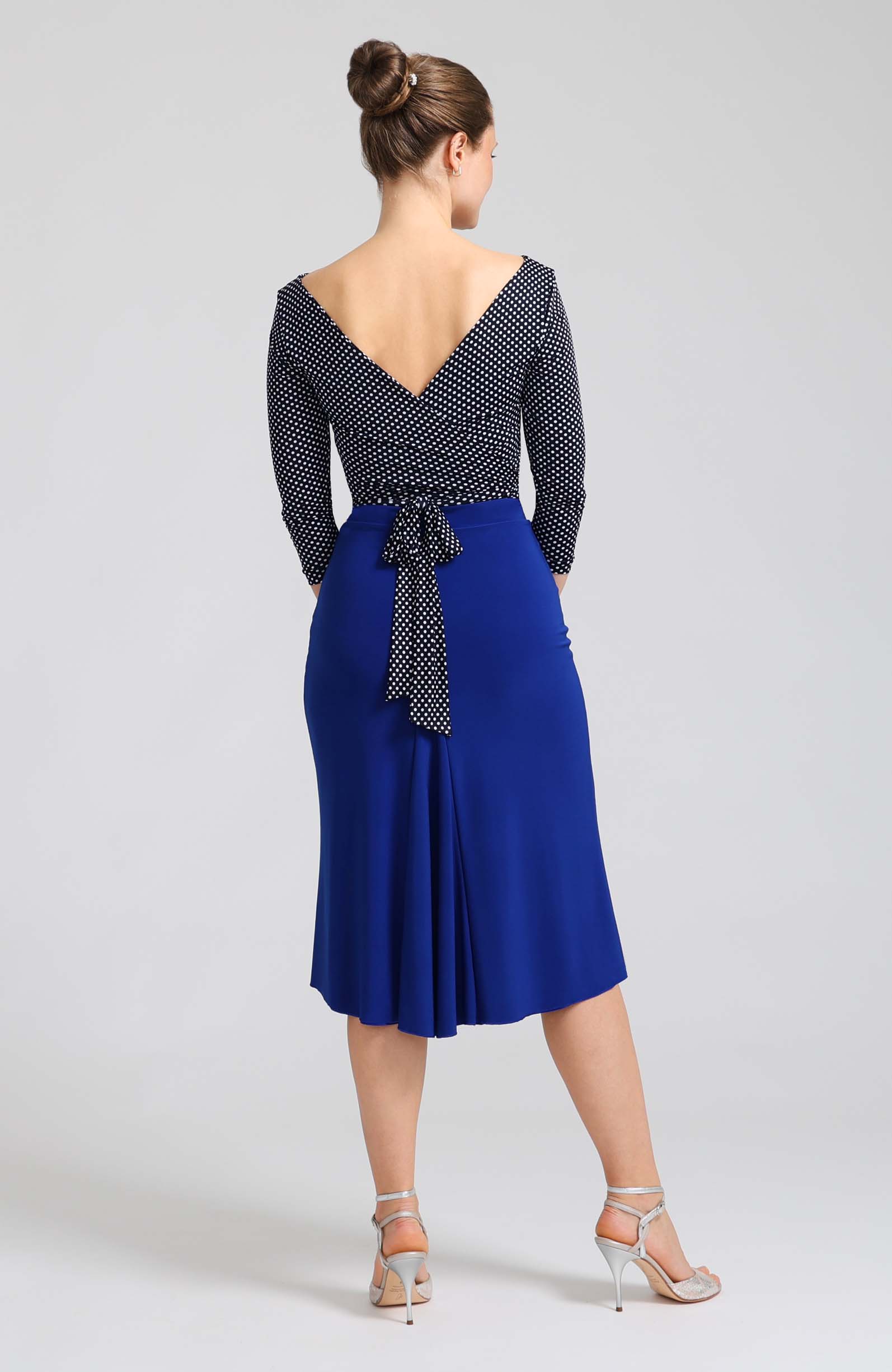 Navy blue polka dot wrap top ELLA with sleeves, featuring a charming V-back that ties into a beautiful bow.
