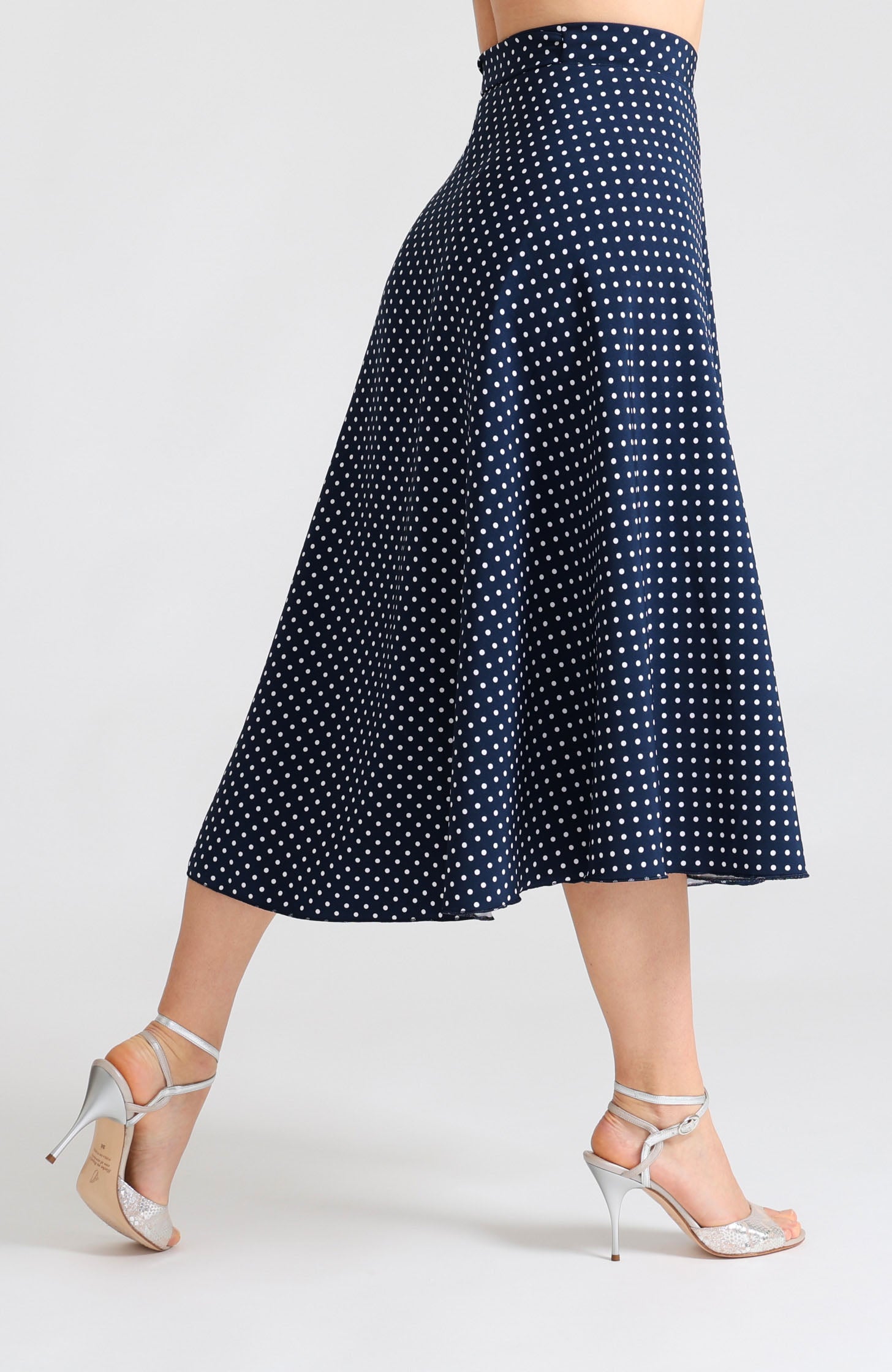 Long wrap tango skirt in navy blue with white polka dots – fluid movement and elegant wrap design.