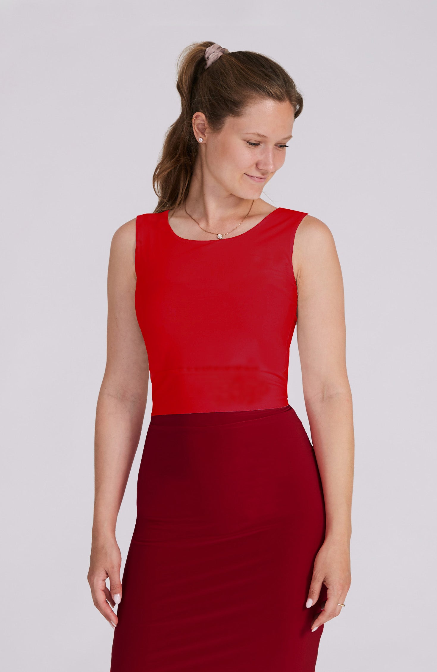 Model wearing the ZOE red tango top with a back bow detail.