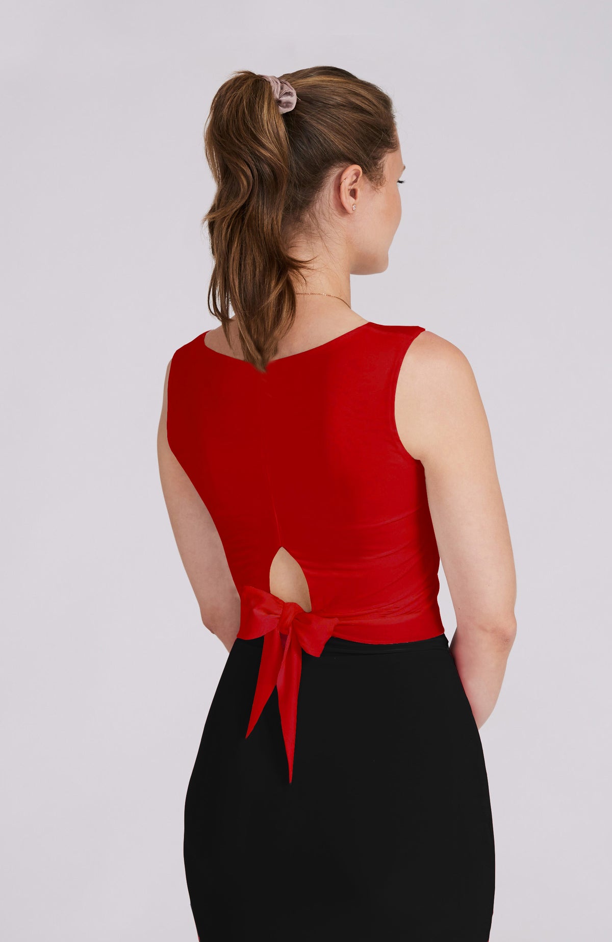 Model wearing the ZOE red tango top with a back bow detail.