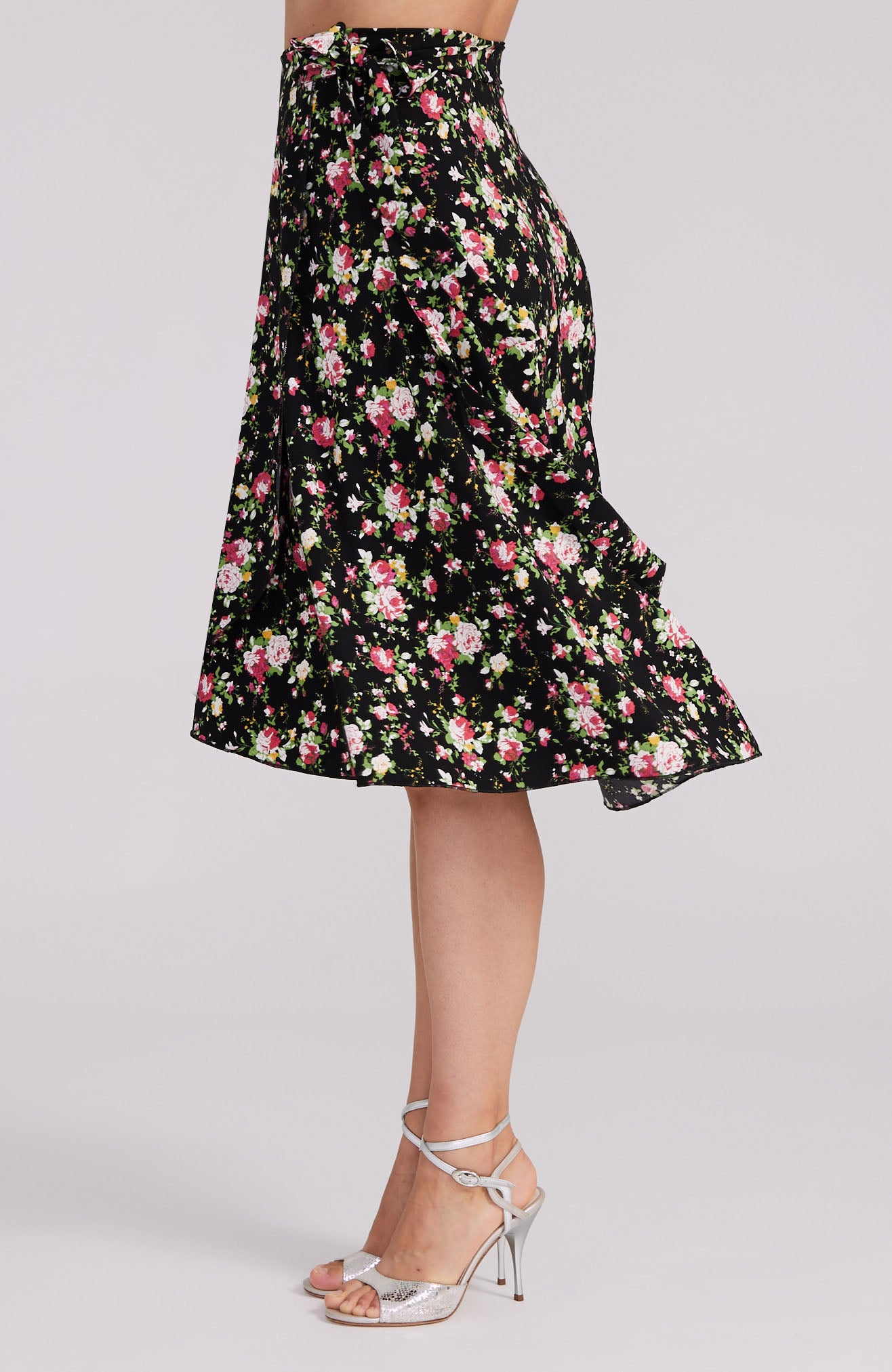 Model wearing the COCO red rose print tango skirt, showcasing the asymmetric wrap design and elegant movement on the dance floor.
