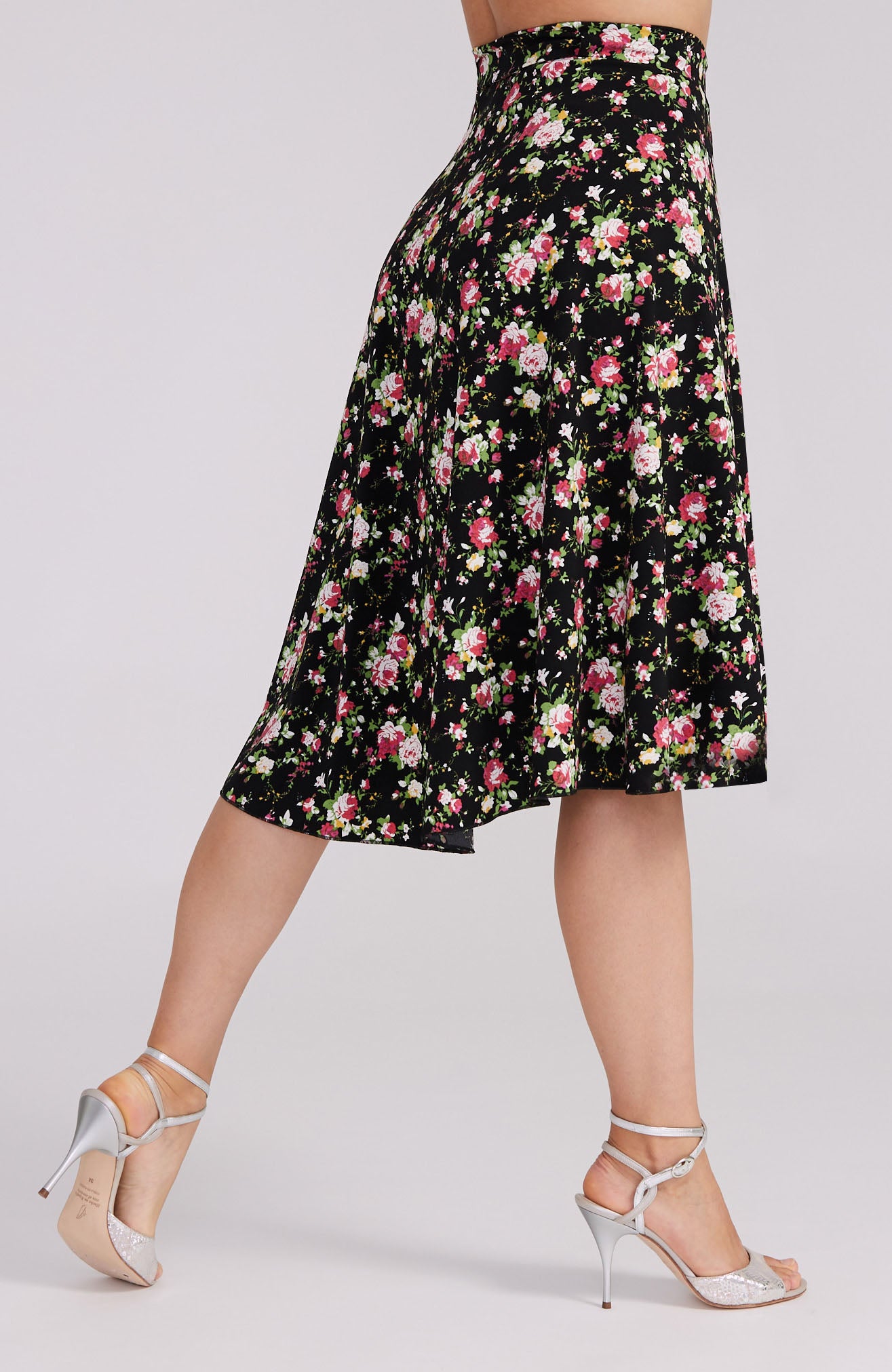 Model wearing the COCO red rose print tango skirt, showcasing the asymmetric wrap design and elegant movement on the dance floor.