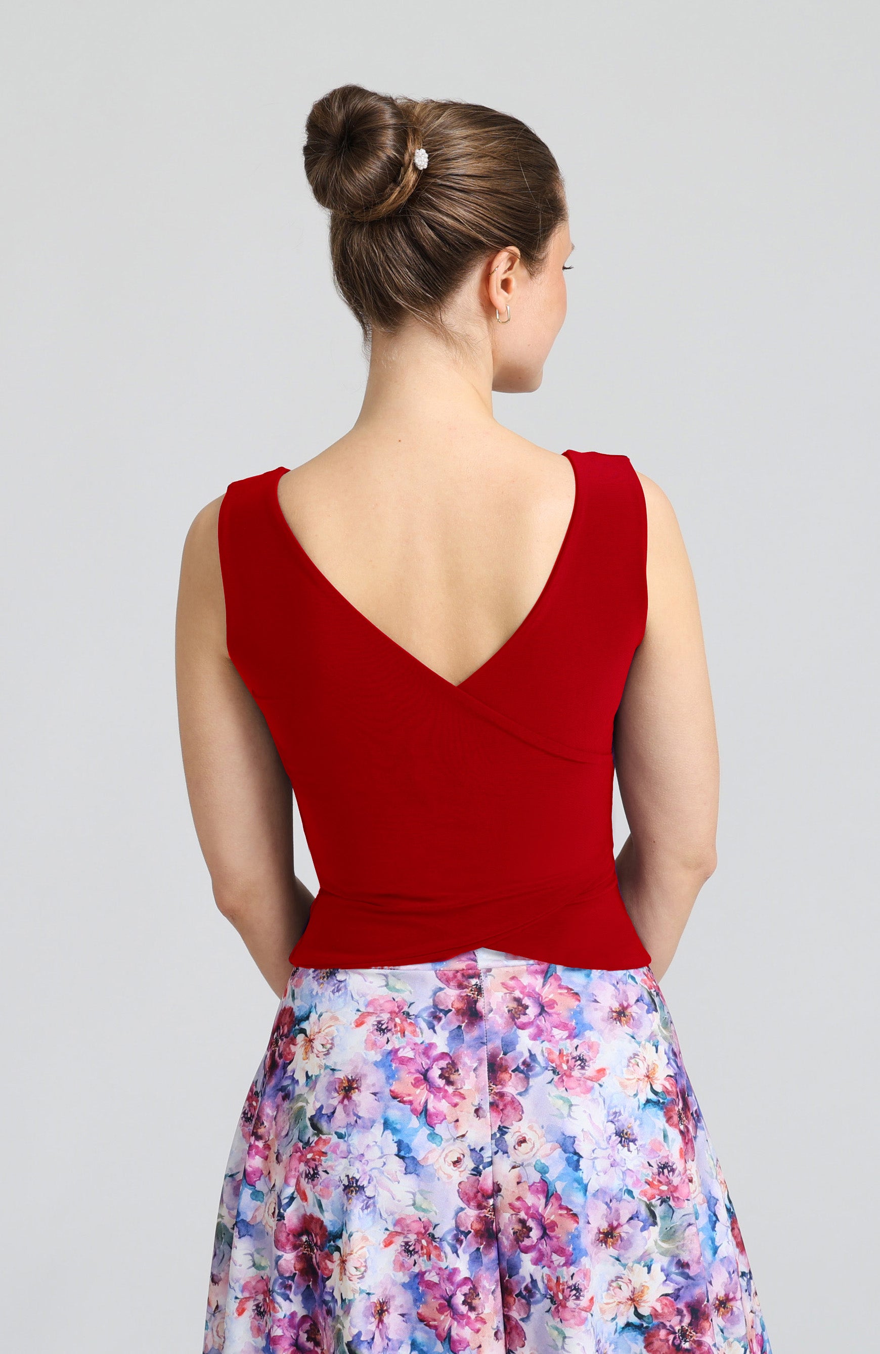 Model wearing the DANIELA cross-back tango top in red, showcasing the elegant open V-shaped back design.
