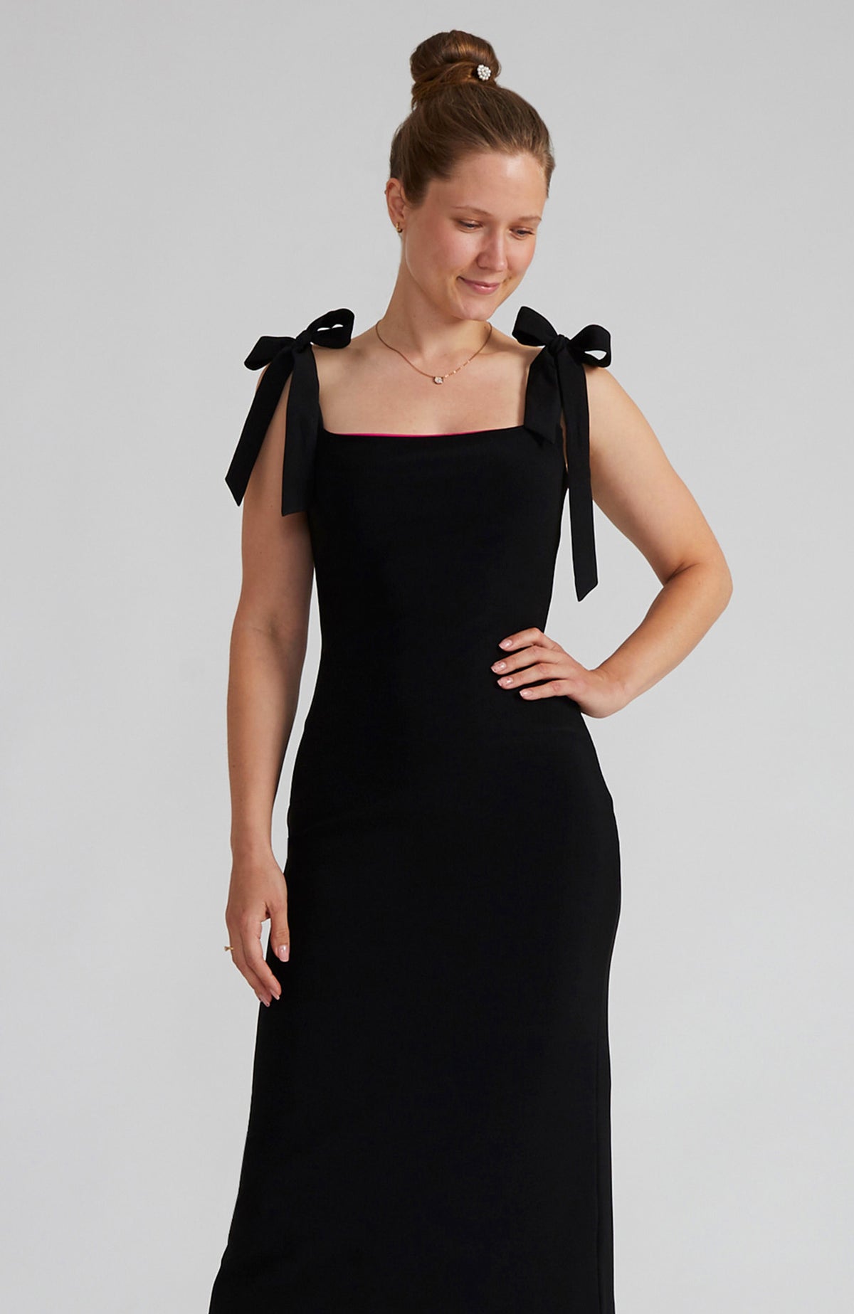 Reversible black and fuchsia tango dress with a bow detail.