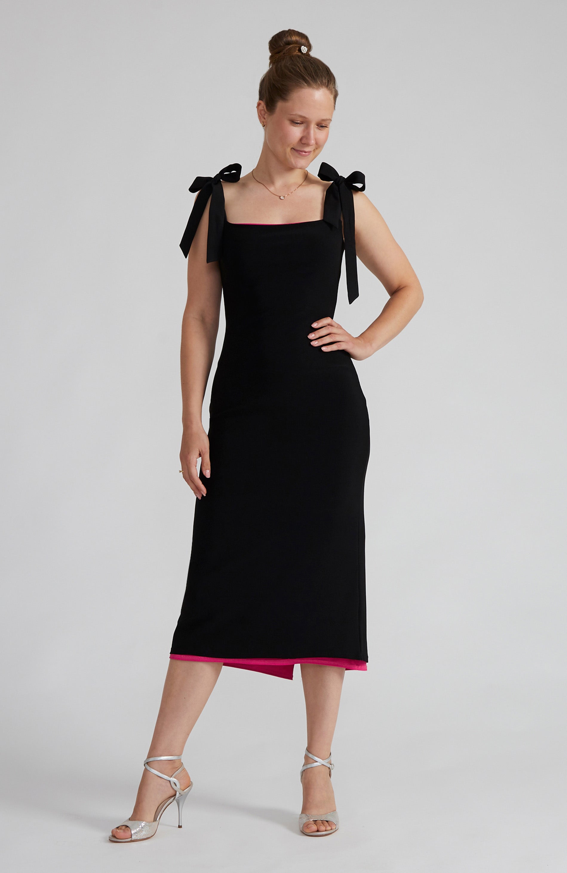 Reversible black and fuchsia tango dress with a bow detail.