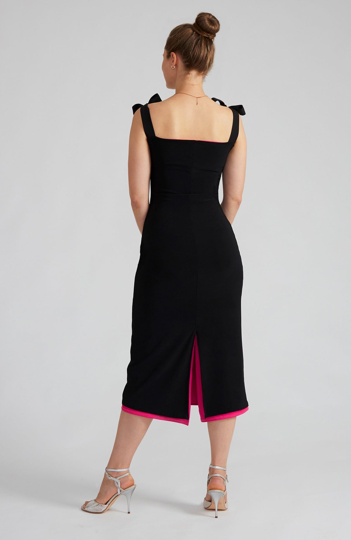 Reversible black and fuchsia tango dress with a bow detail.