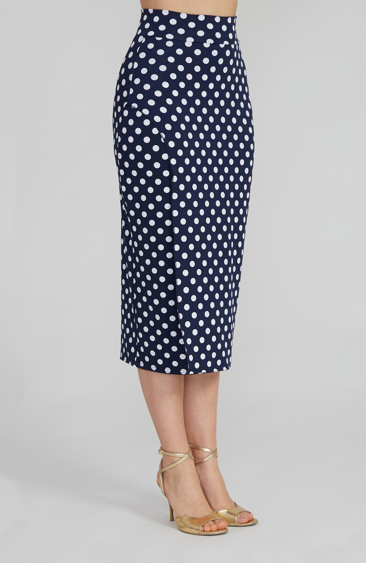 Model wearing the VALERY polka dot tango skirt with a front overlap and back slit, showcasing its fit and elegant movement.