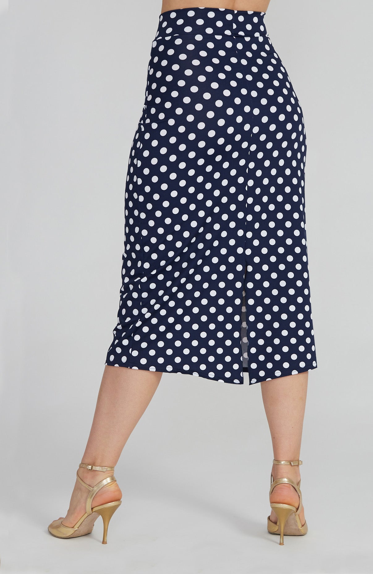 Model wearing the VALERY polka dot tango skirt with a front overlap and back slit, showcasing its fit and elegant movement.
