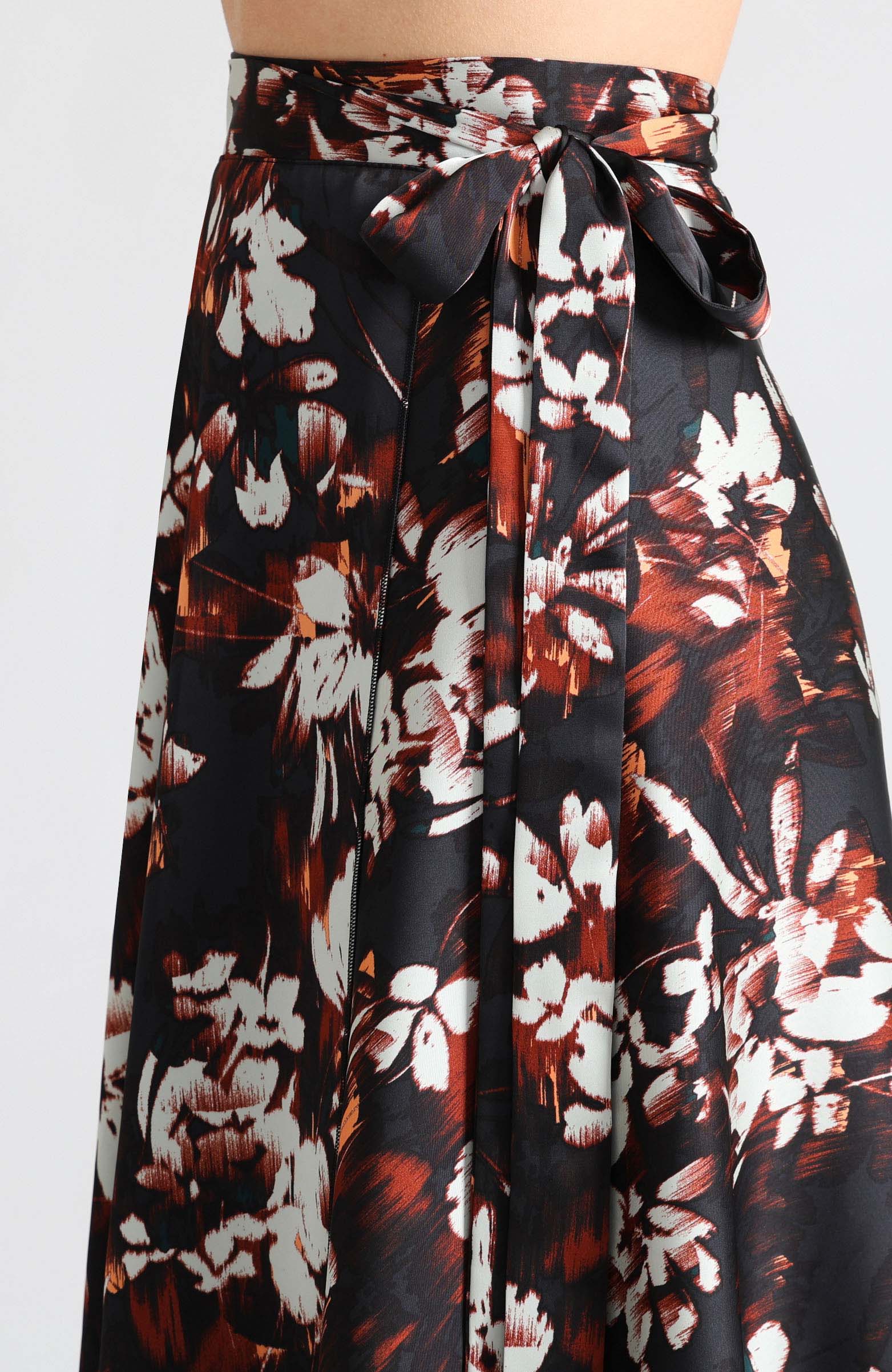 Wrap skirt in dark abstract print with bow.