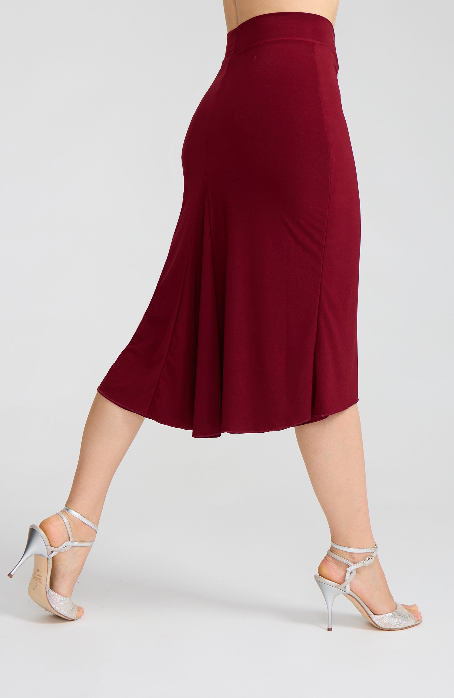 Model wearing the JAZMIN bordeaux red godet tango skirt on the dance floor.