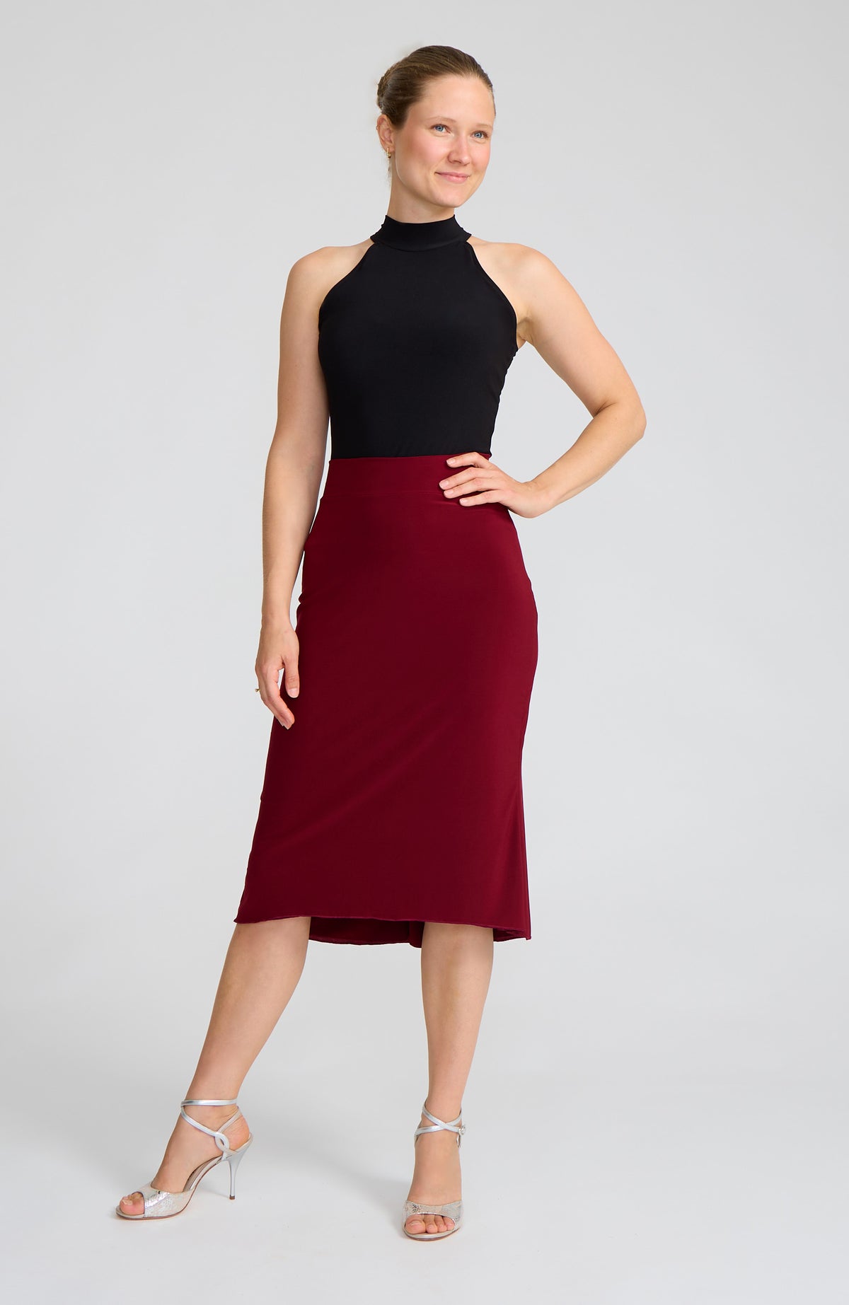 Model wearing the JAZMIN bordeaux red godet tango skirt on the dance floor.