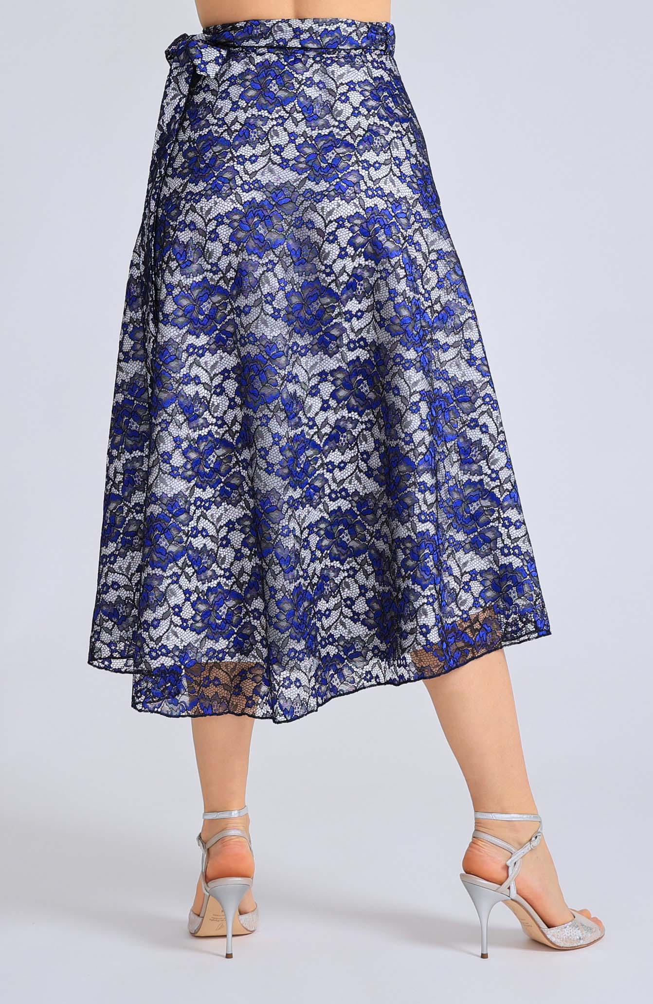 Long blue lace wrap skirt GINA with a soft white lining and an adjustable tie waist, showcasing an elegant flowing silhouette for tango dancing.