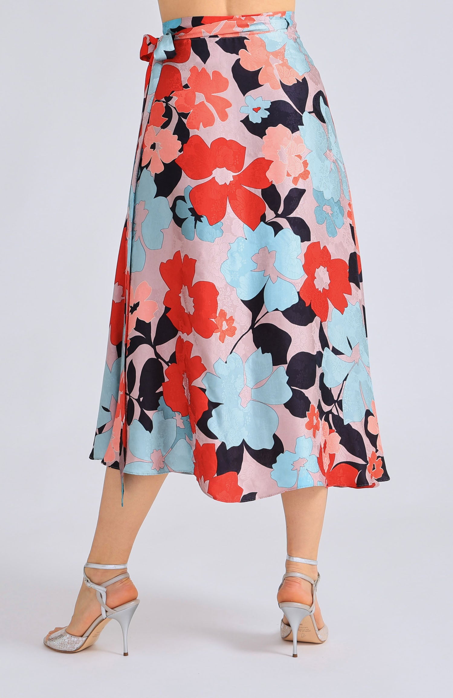 Long wrap tango skirt GINA featuring a vibrant red blossom print and a flowing silhouette that opens elegantly in motion.
