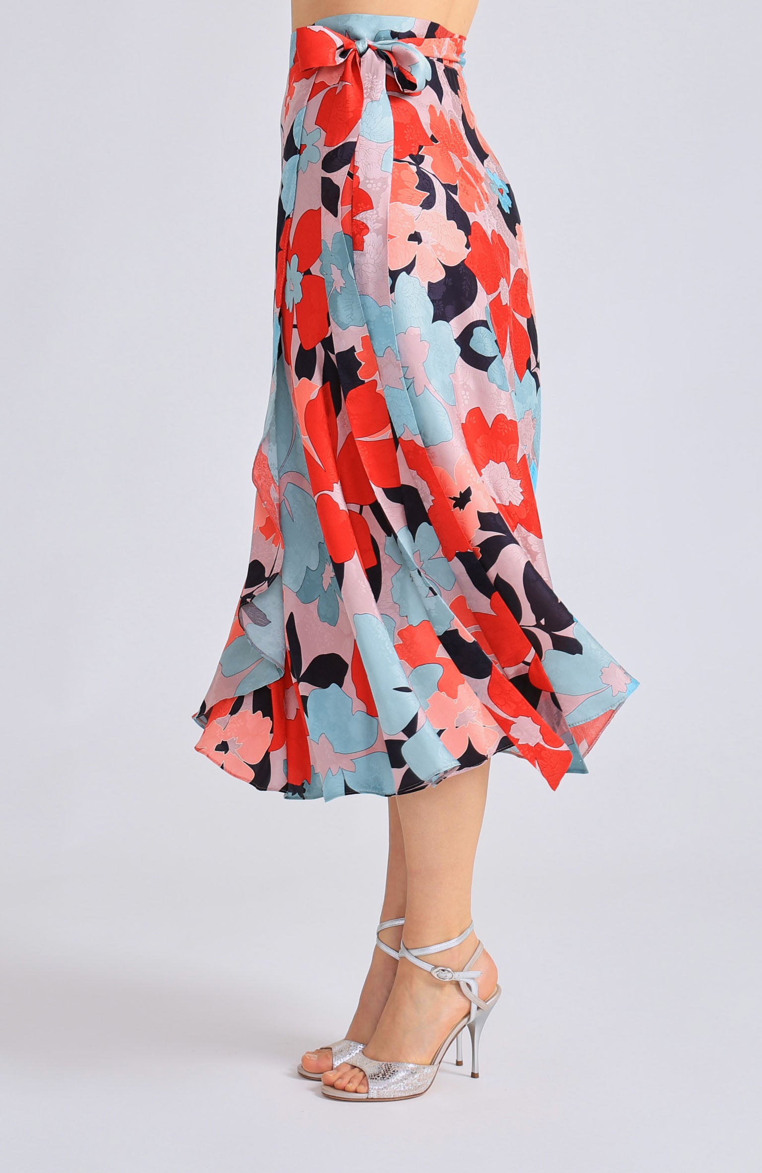 Long wrap tango skirt GINA featuring a vibrant red blossom print and a flowing silhouette that opens elegantly in motion.