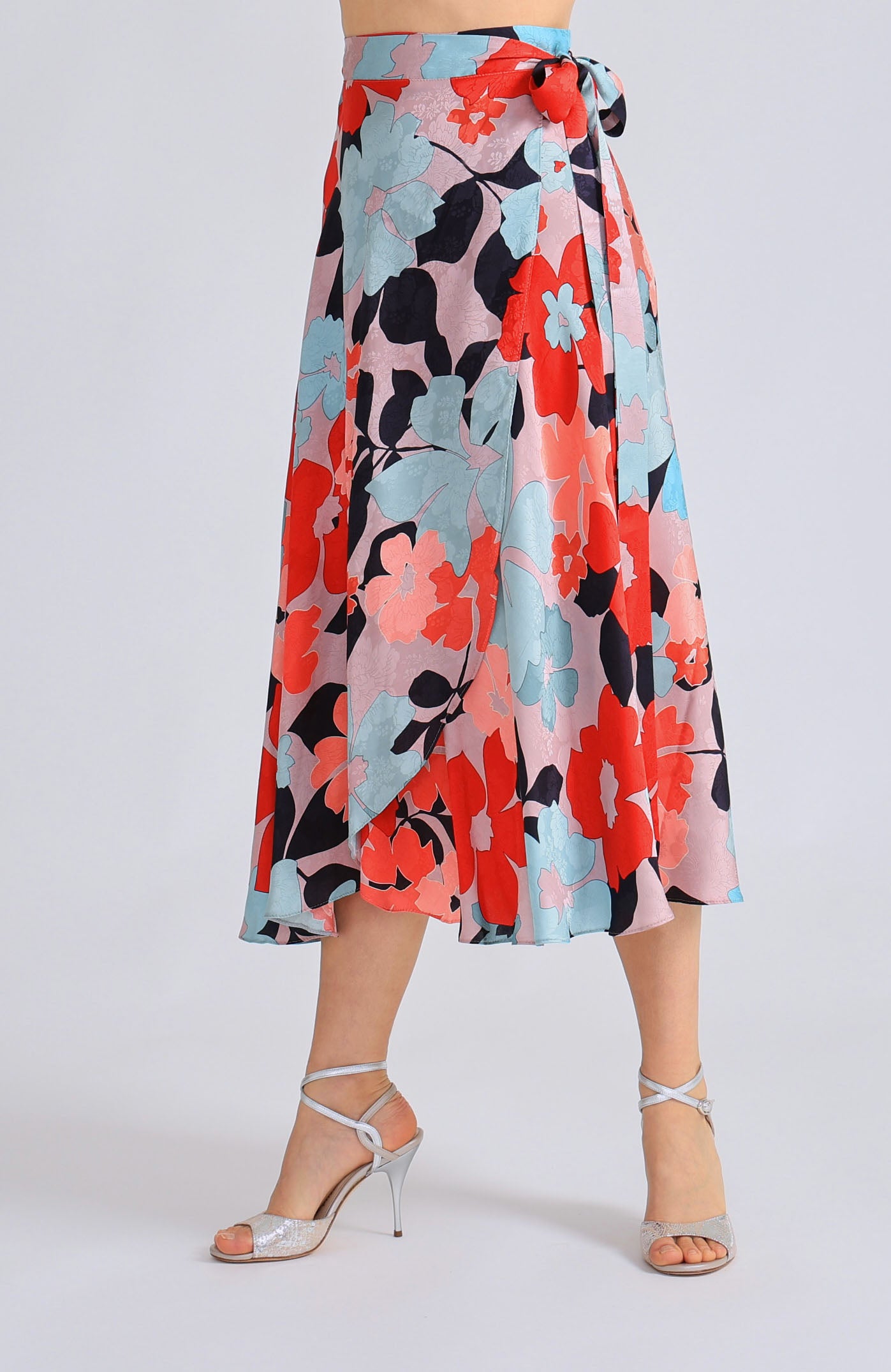 Long wrap tango skirt GINA featuring a vibrant red blossom print and a flowing silhouette that opens elegantly in motion.