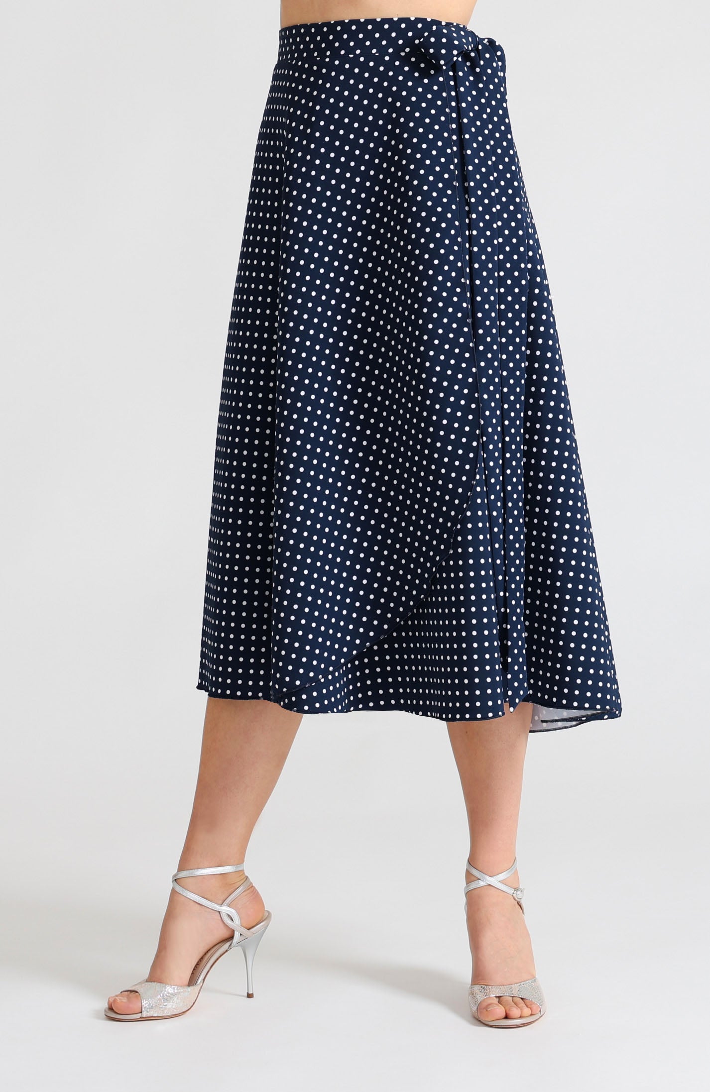 Long Wrap Tango Skirt in navy blue with white polka dots – front view of the flowing fabric.