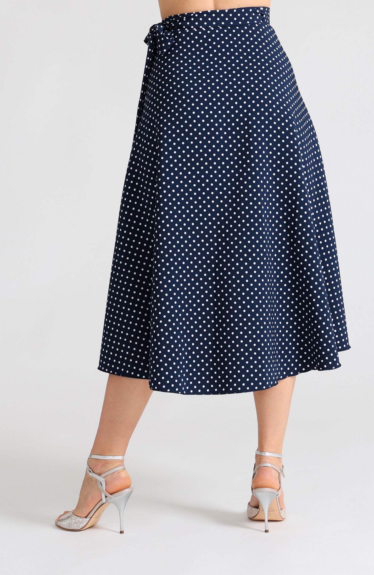 Long wrap tango skirt in navy blue with white polka dots – fluid movement and elegant wrap design.