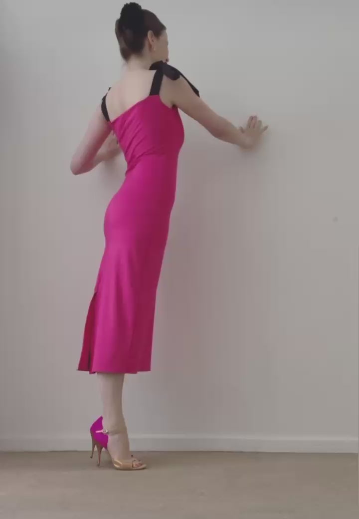 Maude Andrey dancing in the reversible MAUDE dress, transitioning between the fuchsia and black sides.
