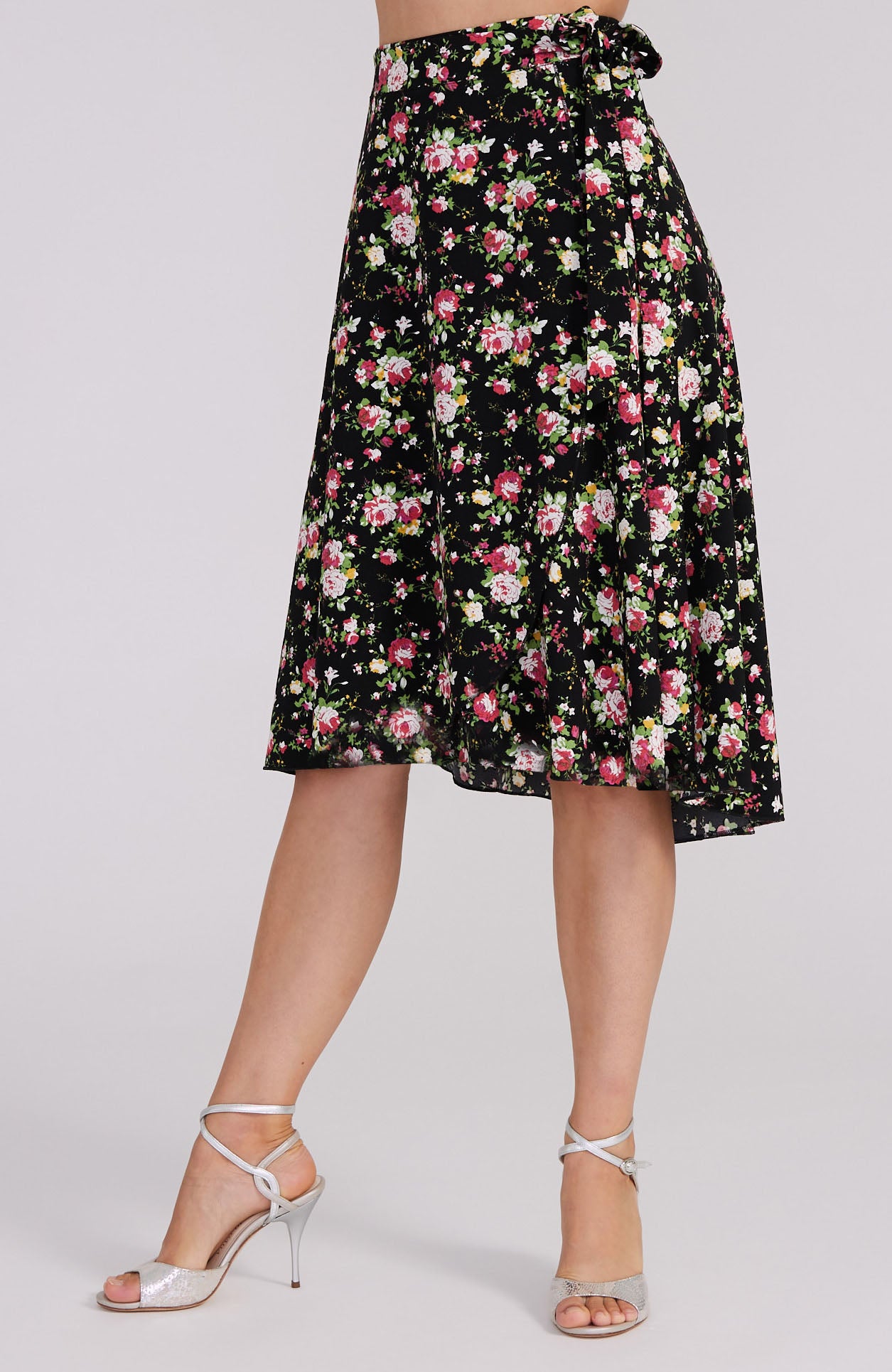 Model wearing the COCO red rose print tango skirt, showcasing the asymmetric wrap design and elegant movement on the dance floor.