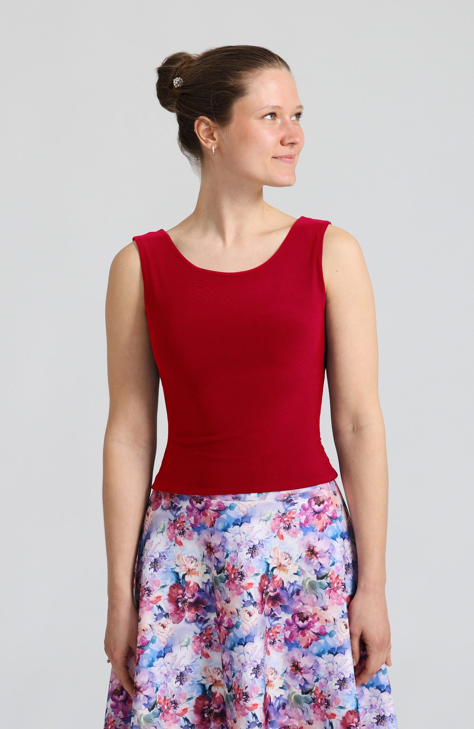 Model wearing the DANIELA cross-back tango top in red, showcasing the elegant bateau neckline.