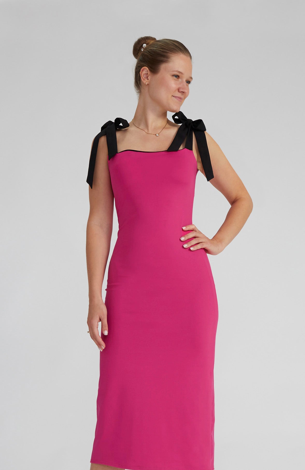 Reversible black and fuchsia tango dress with a bow detail.
