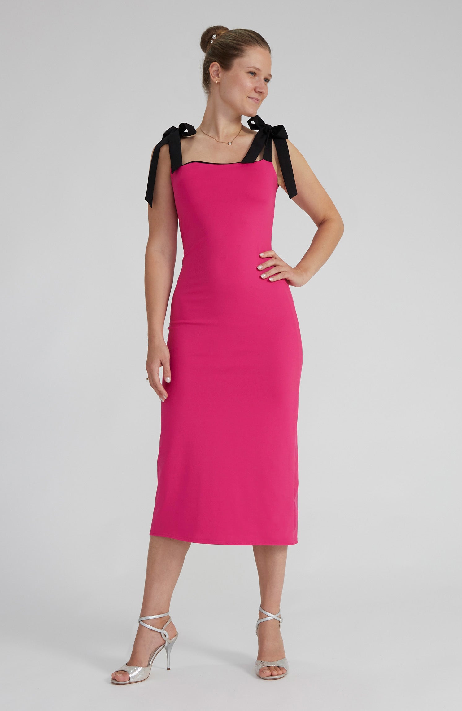 Reversible black and fuchsia tango dress with a bow detail.