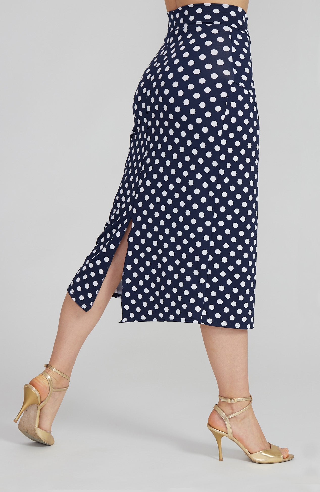 Model wearing the VALERY polka dot tango skirt with a front overlap and back slit, showcasing its fit and elegant movement.