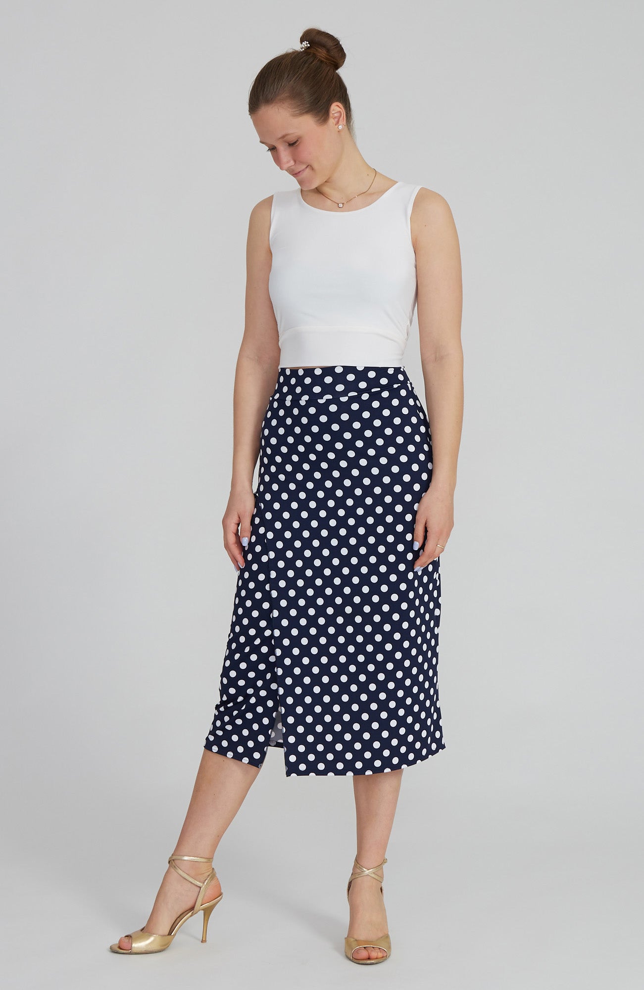 Model wearing the VALERY polka dot tango skirt with a front overlap and back slit, showcasing its fit and elegant movement.
